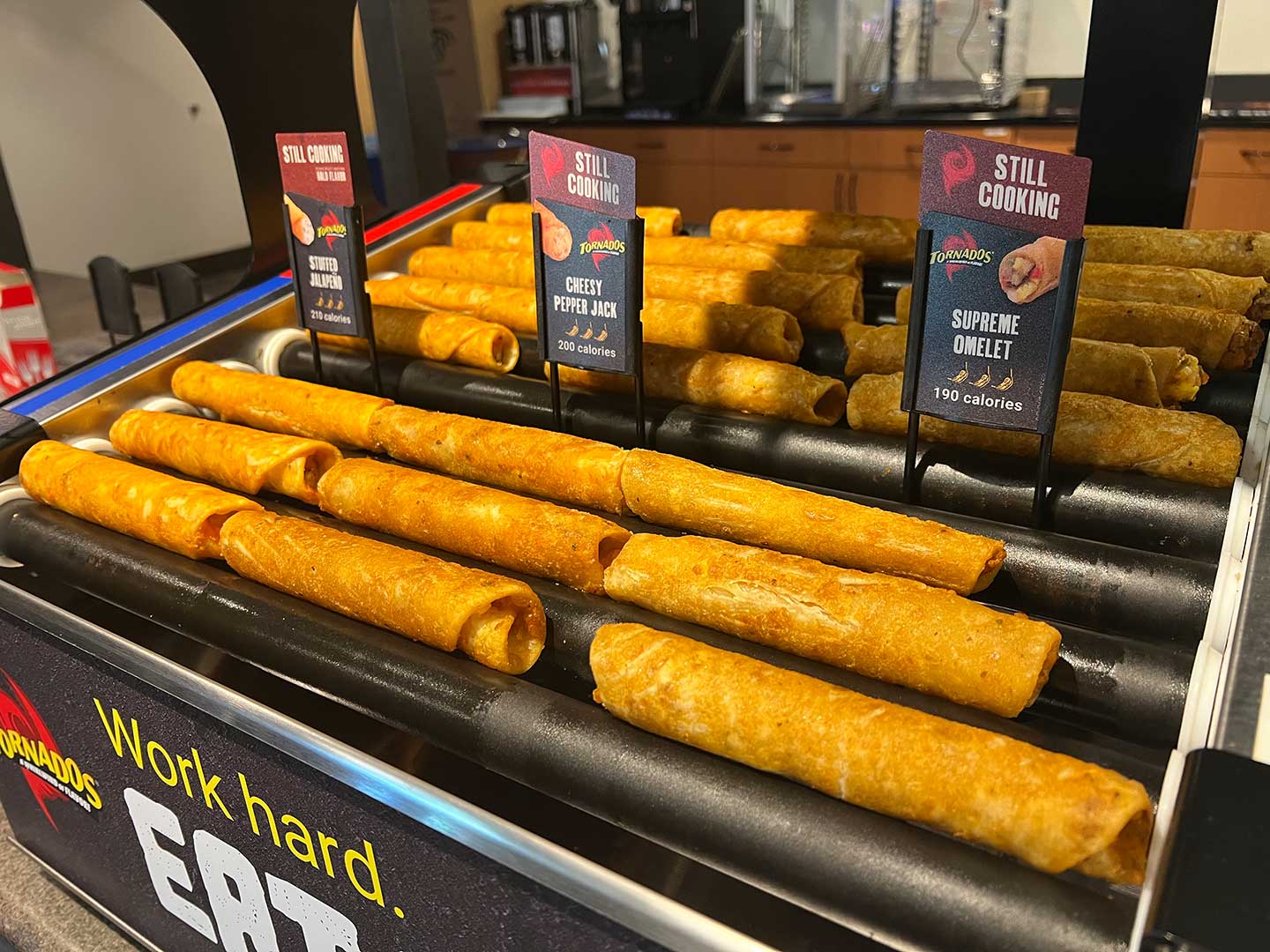 Fresh breakfast items on a commercial roller grill in a convenience store foodservice destination